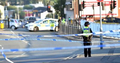 Police investigating incident on main road near town centre as man taken to hospital