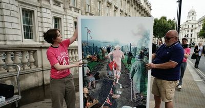 Huge leaving card showing naked Boris Johnson running from chaos delivered to No10