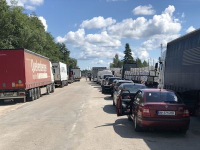 At Latvia's border with Russia, the line grows long, and tempers short