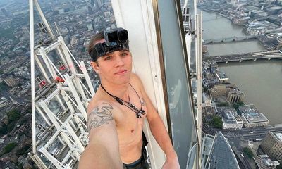 ‘Amazingly uplifting’: barefoot climber greets couple through 40th-floor window of Shard