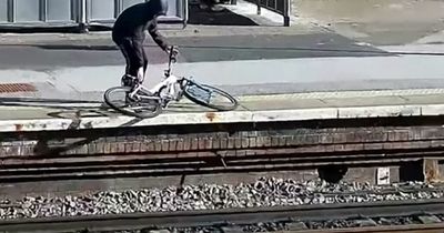 Frightening moment kids throw bike onto live train track in 'wake up call to parents'