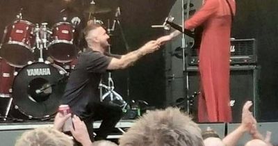 Guitarist proposes to his bandmate girlfriend on the main stage of a rock festival