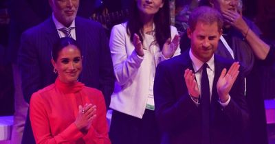 Prince Harry and Meghan arrive on stage for the first stop of their UK tour