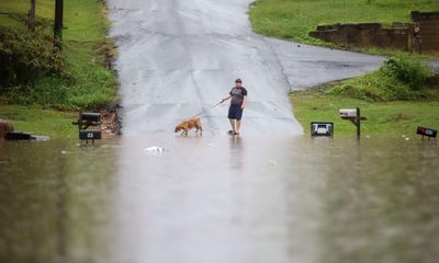 Flash flood watch under way for 80m in eastern US as heatwaves broil west