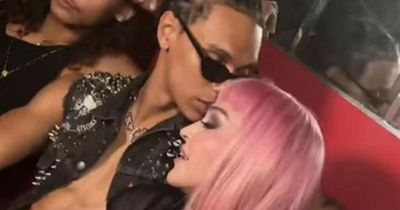 Madonna 'kisses' rumoured 23-year-old lover as pair wear matching leather ensemble