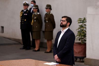 Viral video shows Chile's Boric approached by 'superman' child during constitution speech