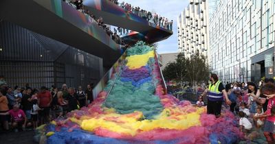 Art installation creates chaotic spectacle and drenches woman in rainbow-coloured foam