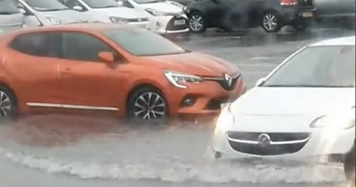 Edinburgh Tesco shoppers struggle through flooded car park during thunderstorm