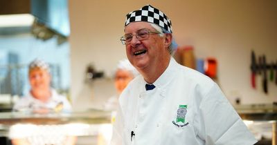 First Minister Mark Drakeford serves lunch to primary school children as universal free school meals rollout starts