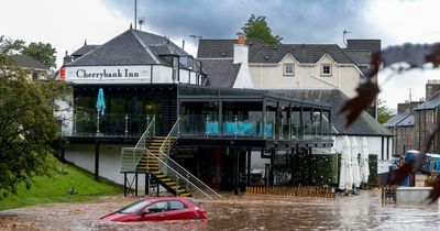 Pub beer garden disappears in flood as Scots stranded with roads closed and trains cancelled