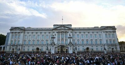 Crowds gather outside Buckingham Palace to pay respect to the Queen as tributes flood in