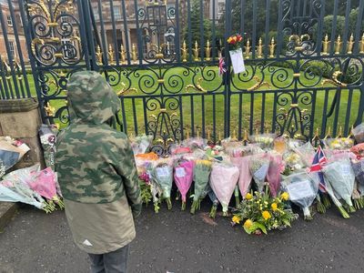 People come to gates of castle to pay respects to the Queen