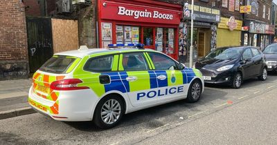 Arrest after man stabbed at row of shops