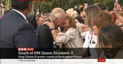 A kiss for a King: Charles goes on Buckingham Palace walkabout amid emotional scenes