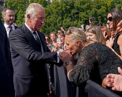 Cheers and kisses for the King as Charles greets well-wishers outside palace