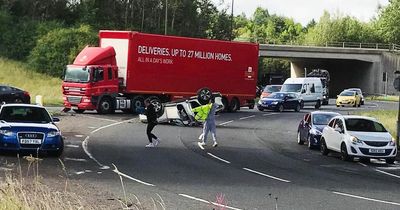 Edinburgh police race to scene as car flips onto its roof on busy road