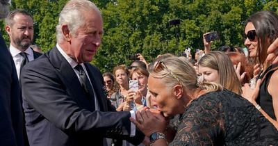 King Charles III kissed on hand by royal fan as he arrives at Buckingham Palace