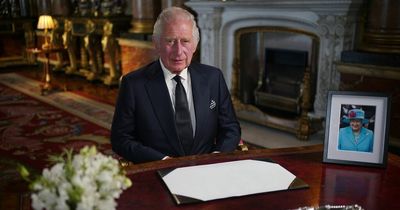 King Charles III poses for first ever royal portrait as monarch with photo of Queen
