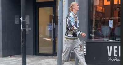 Man City star Erling Haaland begged to join Manchester United as he strolls down the street