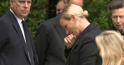 Zara Tindall chokes back tears as she looks at tributes to the Queen at Balmoral