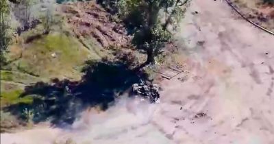 Drone footage shows Russian soldiers thrown off fleeing tank before smashing into tree