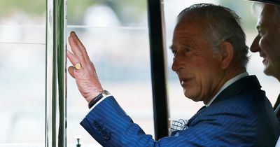 King Charles III gets out of his Rolls-Royce to greet crowds outside Buckingham Palace