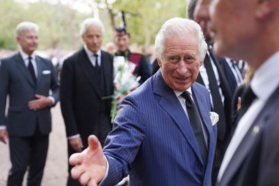 King and Queen shake hands with well-wishers at Clarence House