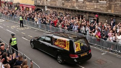 Mourners pay their respects as Queen Elizabeth II's funeral procession makes its way through Scotland towards Edinburgh
