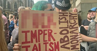 King Charles booed at proclamation as police arrest woman for holding sign