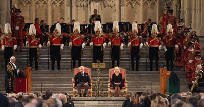Crowds cheer and raise phones as King Charles arrives to address Parliament with the Queen Consort