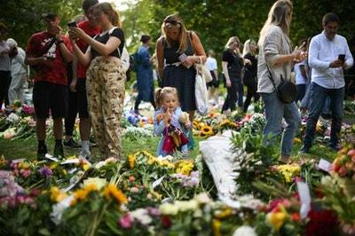 Mourning the Queen at Buckingham Palace — amid the flowers, a triumph of diversity