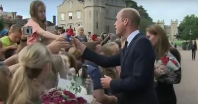 Sweet moment Prince William accepts Paddington Bear toy from girl outside Windsor Castle