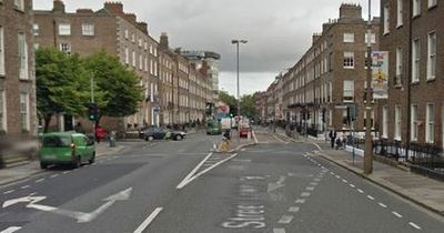 Young man stabbed in city centre apartment as woman arrested