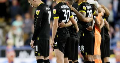 James McClean stands away from team mates during minute of silence for Queen