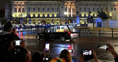 Queen guided home to Buckingham Palace by lights of love as sodden Brits pack streets