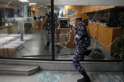 Armed woman breaks into Beirut bank, takes trapped savings