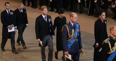 Prince Harry and Meghan Markle stand out as they hold hands at moving service for Queen