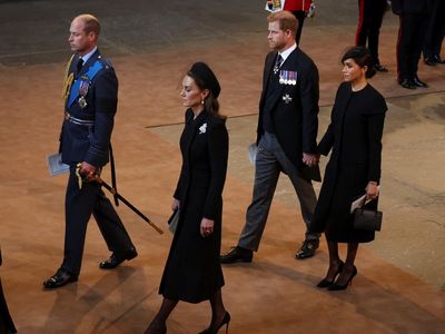 Harry and Meghan praised for holding hands after Queen’s service as other royals stoic in grief