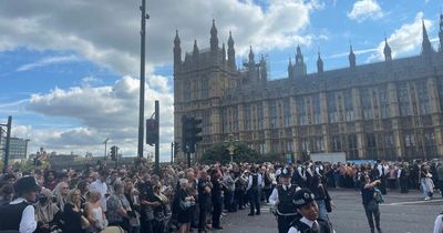 Desperate scenes as the Queen's coffin arrives in Westminster as crowds do all they can to see the procession