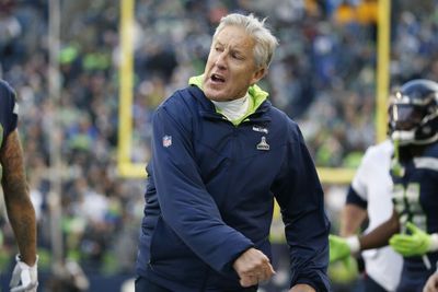 Always Compete: Pete Carroll swats a bug during press conference