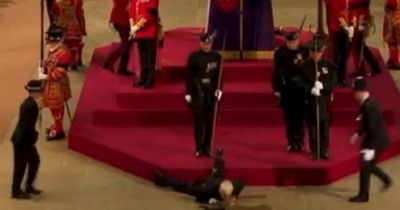 Royal guard collapses next to Queen's coffin on first night of lying in state