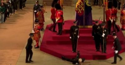 Queen's guard suddenly collapses and falls face first from coffin podium