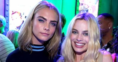 Margot Robbie looks visibly upset as she leaves home of friend Cara Delevingne