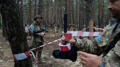 Ukraine finds mass burial site containing more than 440 bodies in forest near recaptured city of Izium, police say