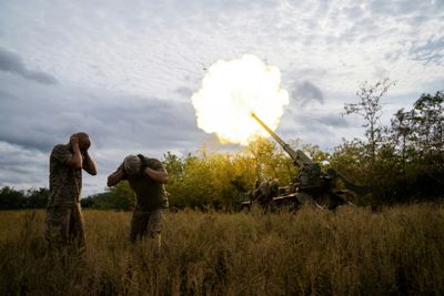 Ukraine reveals discovery of mass grave as US announces new aid