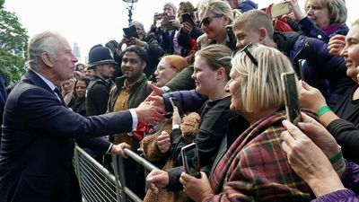 King Charles III meets people waiting in line to see Queen Elizabeth's coffin