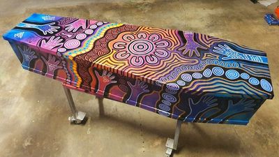 Aboriginal artist Allan McKenzie paints coffins using vibrant dot-painting techniques
