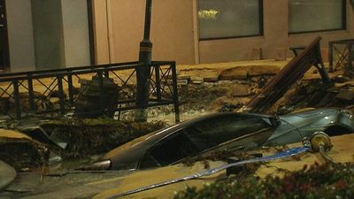 Car swallowed by sinkhole in Perth suburb as burst water main leaves dozens without running water