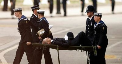 Police officer collapses during Queen's funeral and is carried away on stretcher