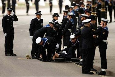 Police officer on duty during Queen’s funeral collapses and needs stretcher